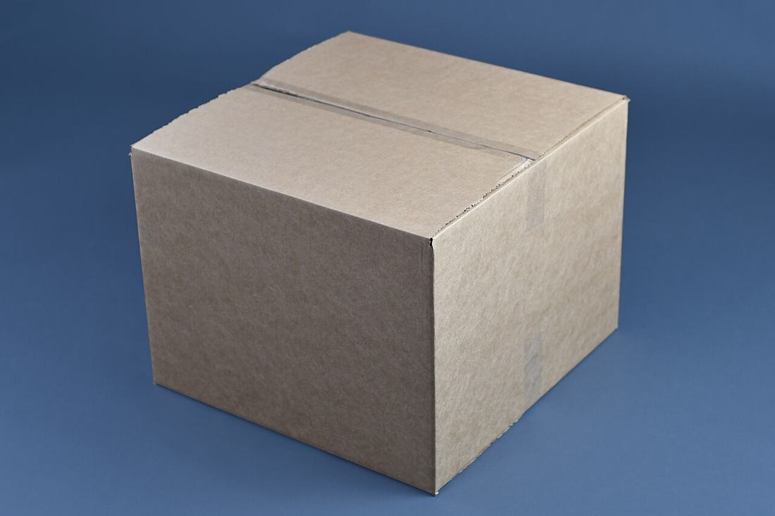 A large cardboard moving box, taped closed