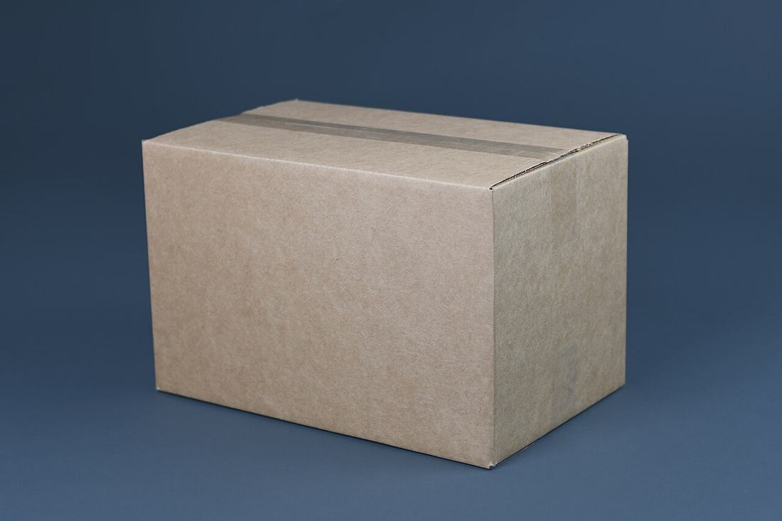 A small cardboard moving box, taped closed